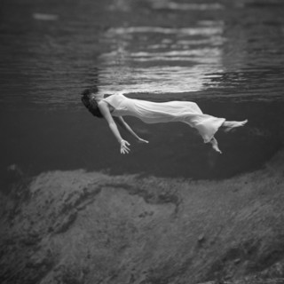 Weeki Wachee, Florida:  1947.
An underwater fashion photograph of a woman, wearing a long gown,