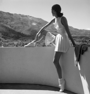 Woman Sitting On Patio Wall