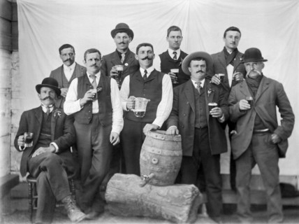 Men Around A Keg Of Beer