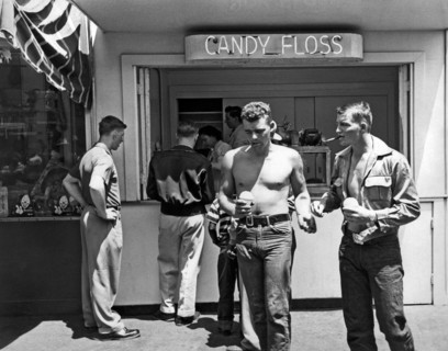 San Francisco, California:  c. 1955.
Two young men walk past a cotton candy stand with snow cones