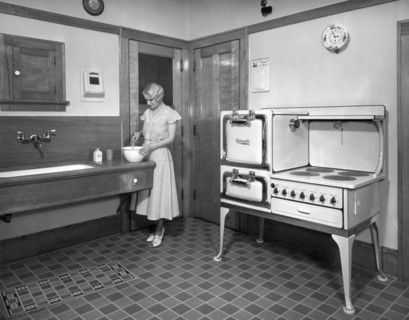 A Woman Cooking In Her Kitchen