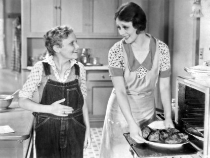 United States:  c. 1934.
A young teenager eagerly antiicipates the dinner his mother is taking out