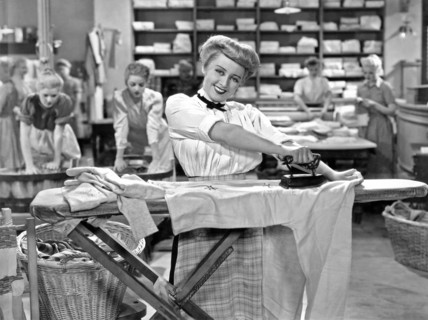 Woman Ironing In Laundry