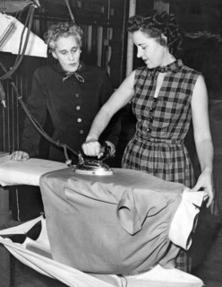 A Woman Irons A Shirt