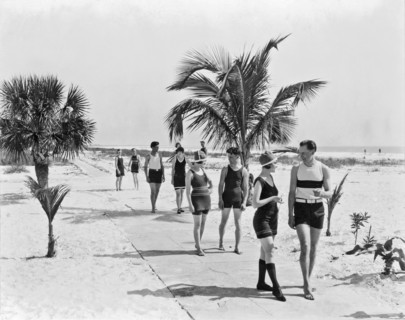 Couples strolling along the pathway on the beach.
