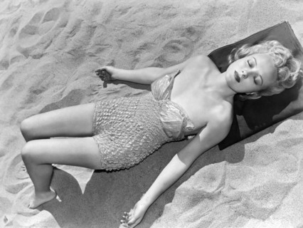 Woman Sun Bathing At The Beach