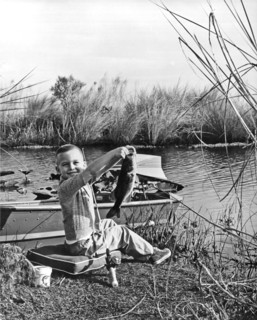 A Boy Holds Up His Catch