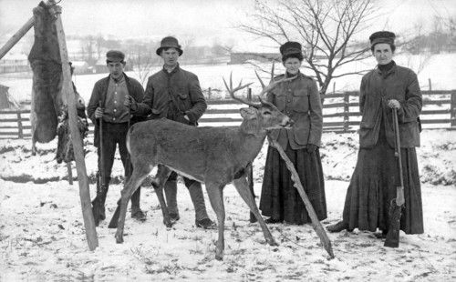 Four hunters and their game.