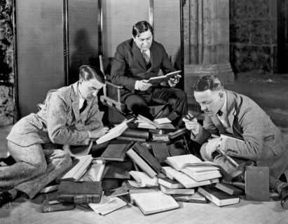 Three Men Searching Books