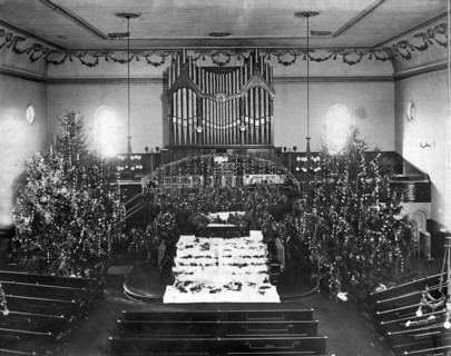 The interior of a church decorated for Christmas.