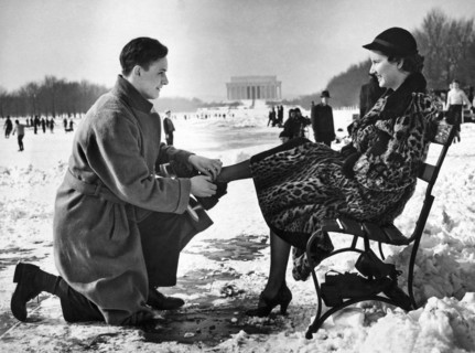 Man Lends A Helping Hand To Put On Skates