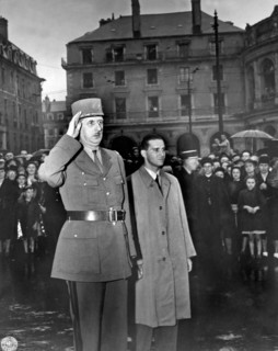 Rennes, France:  August 21, 1944.
General Charles de Gaulle salutes in the town square of Rennes,