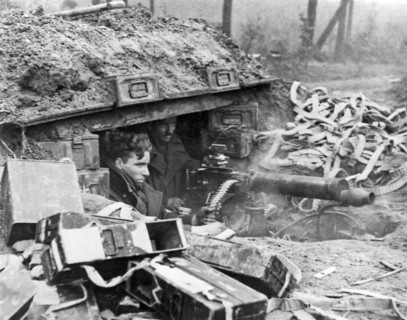 British soldiers with a Vickers machine gun give support to advancing infantrymen during an offensive at Nijmegen in the Netherlands.