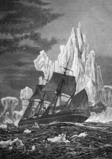 Sailing ship facing an iceberg