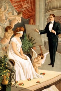 Hypnotist and blindfolded woman with angels on stage 1910