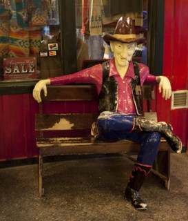 Cowboy sits on bench at Wall Drug in South Dakota 2006