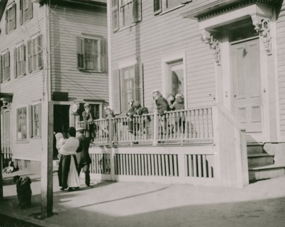 Exterior of Sprague House Settlement Providence, on Saturday morning. The house was so full that these children could not go in.  1912