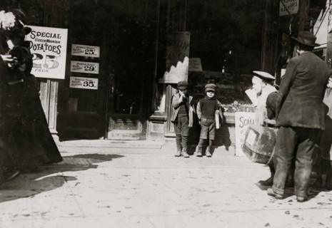 7 year old twins selling newspapers in front of newsstand 1909
