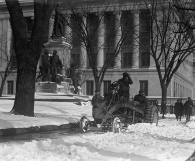 A Ford Tractor cleans snow on DC Street 1924