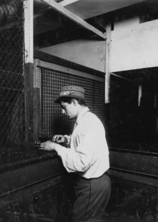 A Postal Telegraph boy learning to send messages during spare moments. 1910