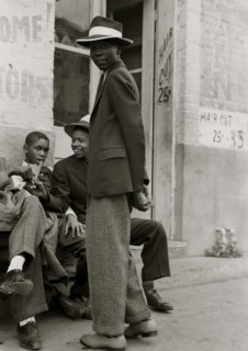 African American boys wait outside of barber shop 1938