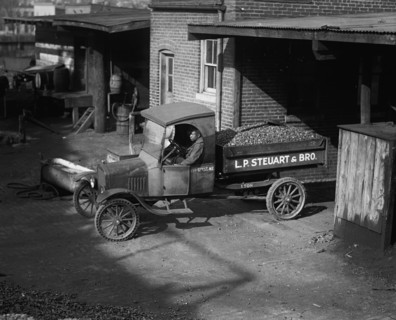 African American Driver has a load of coal ready for delivery the company truck 1923