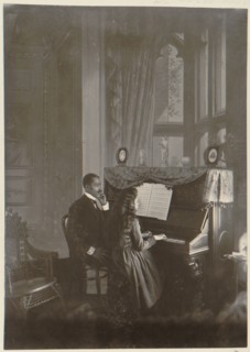 African American man giving piano lesson to young African American woman 1899