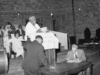 African American Woman Pastor leads her congregation in Prayer 1941