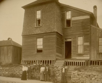 African Americans standing on sidewalk in front of house in Georgia 1899