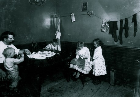 Doing crochet on underwear in dirty kitchen 1912