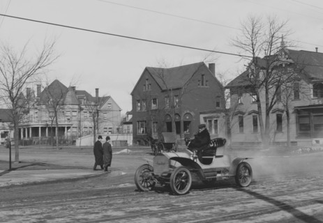 Auto Trundles down city street 1908