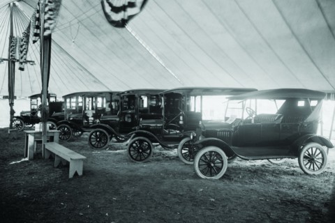 Automobiles on Display in Tent Under American Flag Banners 1921