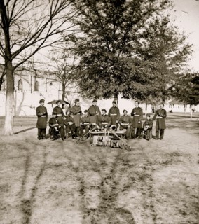 Band group seated behind their instruments 1863
