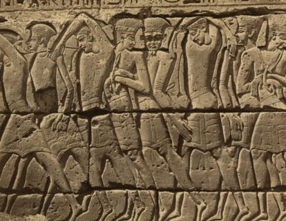 Bas-relief of several men, standing, left of the door of the Great Temple at Medinet-Abou 1880