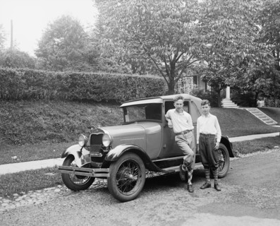 Boys standing next to a coupe