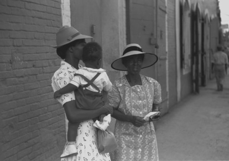 Mother and children waiting on the main street on Sunday 1942