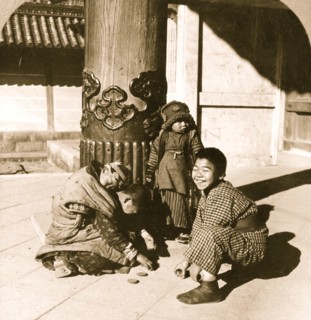 Children playing at the entrance to the temple, Nagoya, Japan 1902