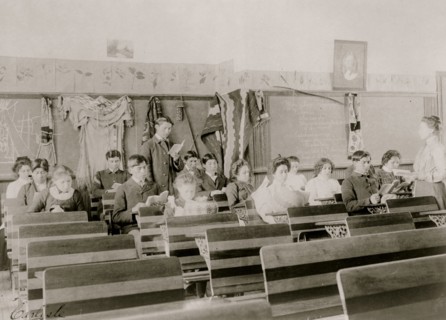 Classroom at the Indian Industrial School, Carlisle, Pennsylvania, showing teacher observing students reading. 1901