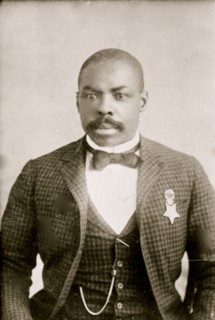 Corporal Isaiah Mays, half-length portrait, seated, facing front 1900