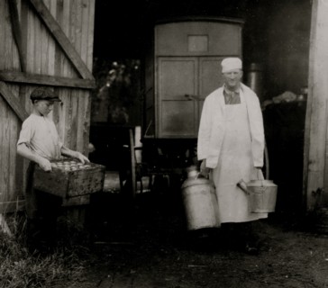 Loading Mill and other Dairy products from the farm into the wagon driven by a young man 1916