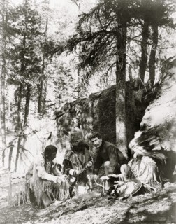 Ernest Thompson Seton, with three Blackfeet Indians, demonstrating how to start a fire 1917