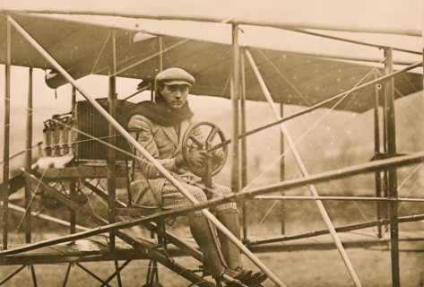 F.L. de Riemsdyk at pilot wheel of Curtiss aeroplane 1909