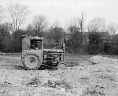 Ford Tractor with Drag line pulls earth