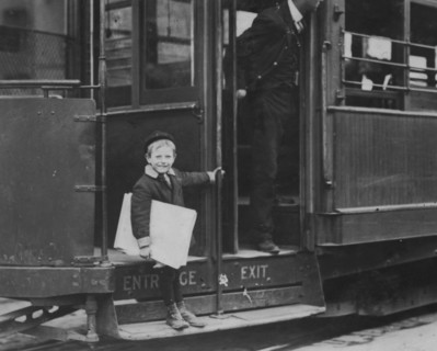 Francis Lance, 5 years old, 41 inches high. Sells regularly on Grand Avenue. He jumps on and off moving cars at risk of life. 1910