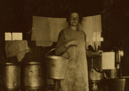 Holding milk pails by a cream separator 1916