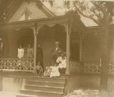 Home of an African American lawyer, Atlanta, Georgia, with men, women, and children posed on porch of house 1899