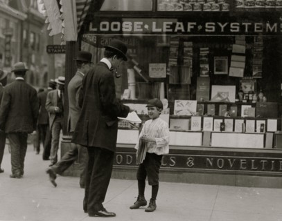 James Lequlla, Italian newsboy, 12 years of age. Selling newspapers in front of a stationery store. 1910