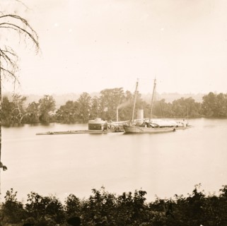 James River, Virginia. U.S. monitor CANONICUS taking on coal from a schooner 1864