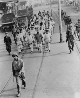 Japanese prisoners of war being guarded by Americans--probably in the Philippines 1944