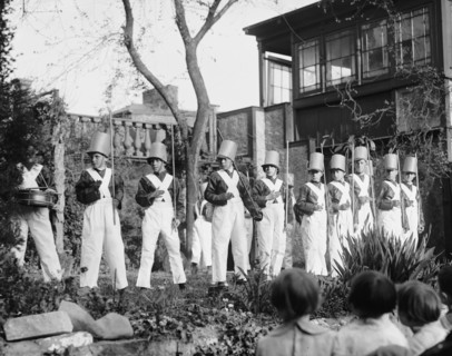 Line of Boys pose as Soldiers with inverted pails on their heads 1923